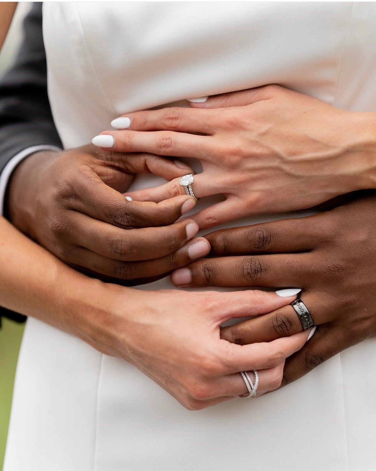 Close-up of the couple's hands and wedding rings