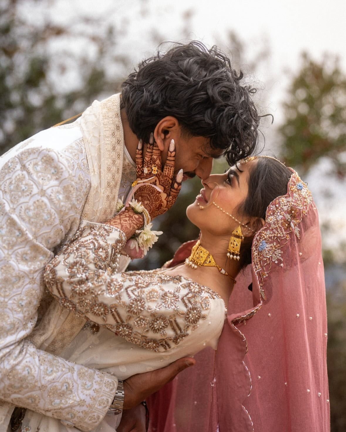 Couple embracing outdoors in traditional attire